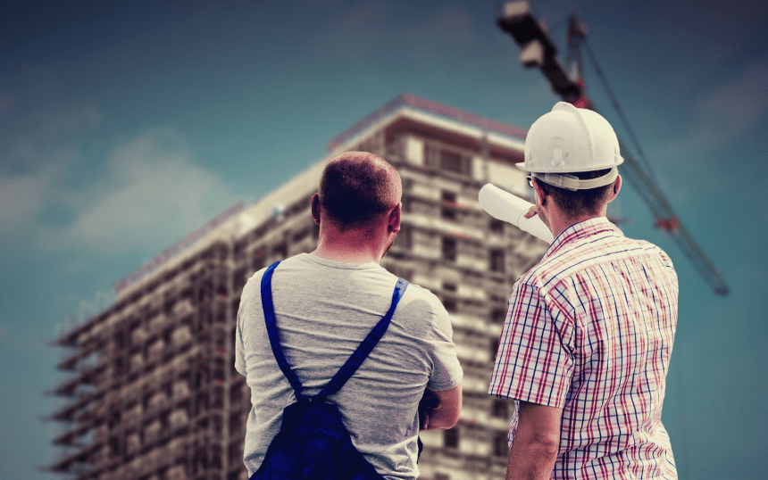 Two men looking at a building being built
