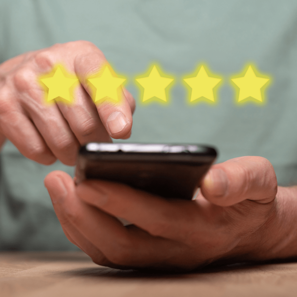 A man using his phone to leave a 5 star review