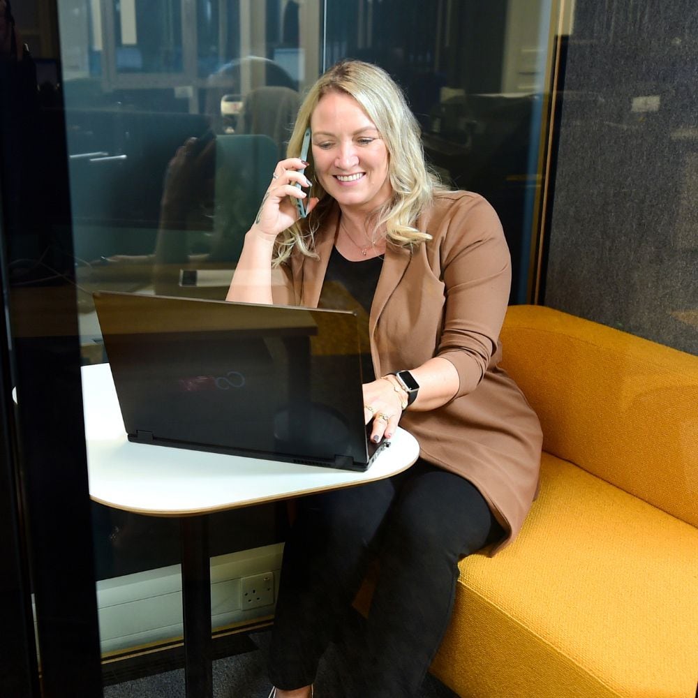 Sue Mountford on the phone to a client