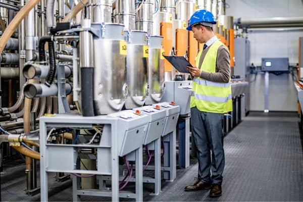 A man doing an assessment on a piece of machinery